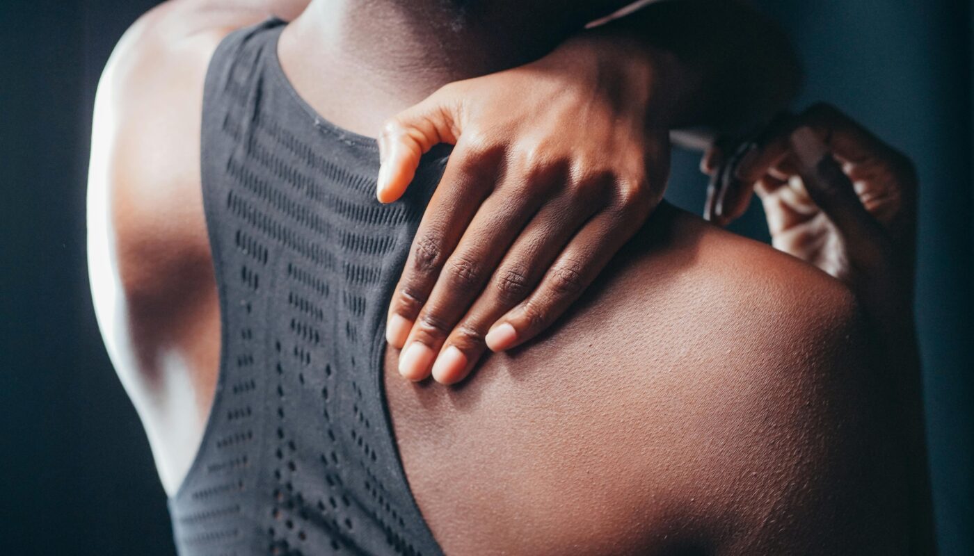 Photo by Kindel Media: https://www.pexels.com/photo/a-woman-holding-his-back-7298904/