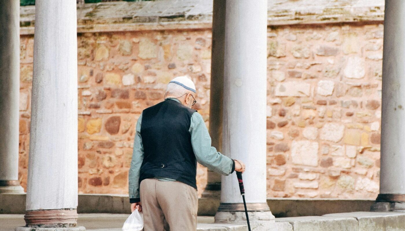Photo by Selenay Yıldırım: https://www.pexels.com/photo/senior-in-vest-with-walking-stick-on-sidewalk-in-town-25435895/