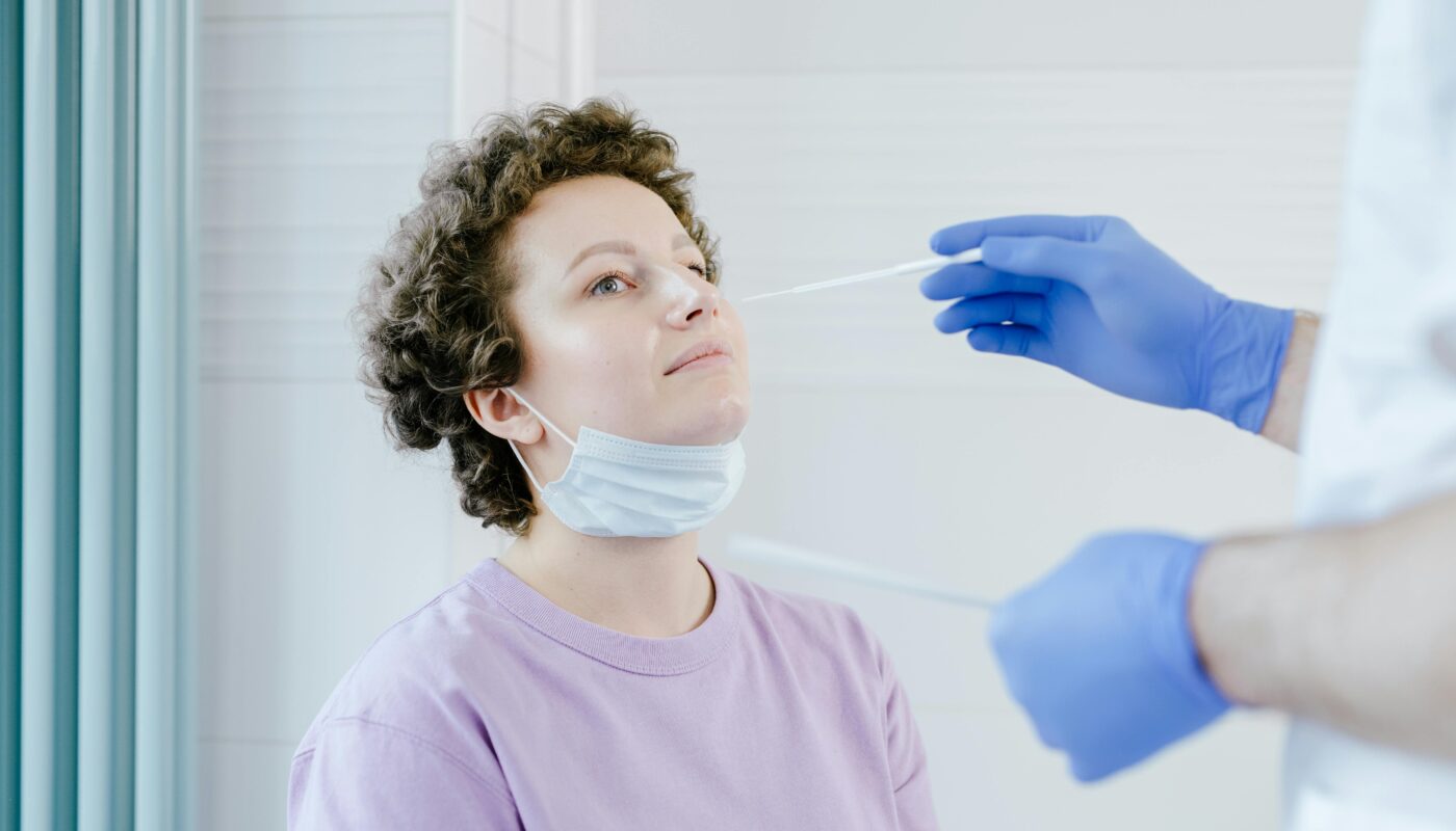 Photo by SHVETS production: https://www.pexels.com/photo/a-woman-getting-a-swab-test-8413191/