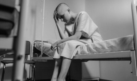 Photo by Tima Miroshnichenko: https://www.pexels.com/photo/grayscale-photo-of-a-hairless-girl-sitting-in-the-hospital-ward-6010877/