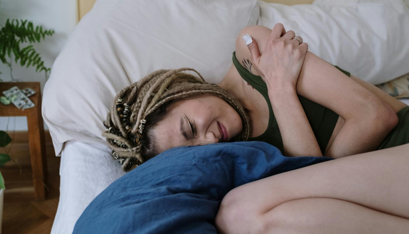 Photo by cottonbro studio: https://www.pexels.com/photo/woman-suffering-from-a-stomach-pain-lying-down-on-bed-6542699/