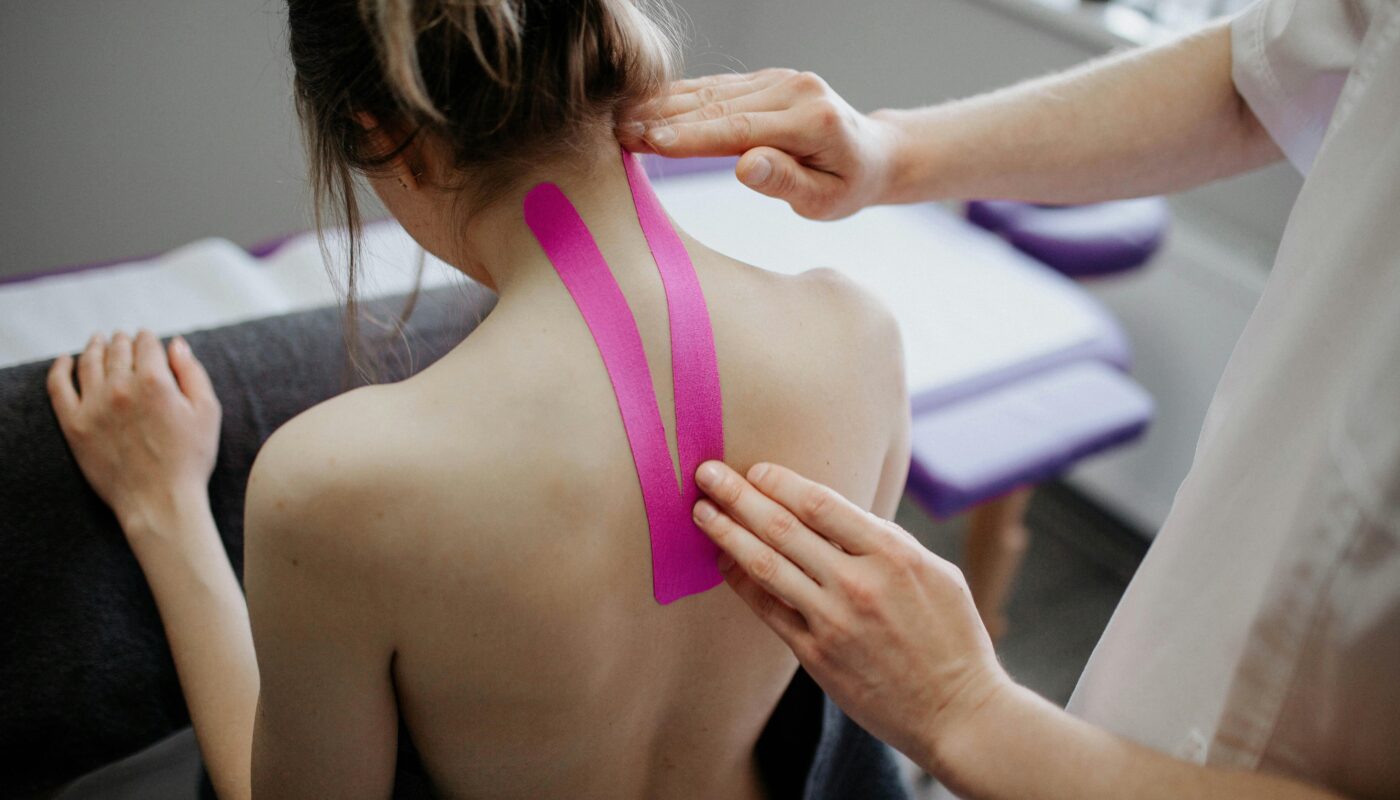 Photo by Danik Prihodko: https://www.pexels.com/photo/person-making-taping-to-woman-s-neck-8219056/
