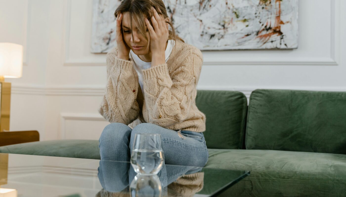 Photo by MART PRODUCTION: https://www.pexels.com/photo/a-sad-woman-sitting-on-a-sofa-7699423/