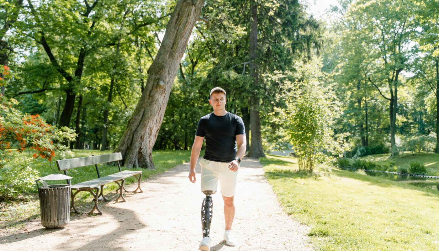 Photo by MART PRODUCTION: https://www.pexels.com/photo/a-man-with-prosthetic-leg-walking-in-the-park-8436890/