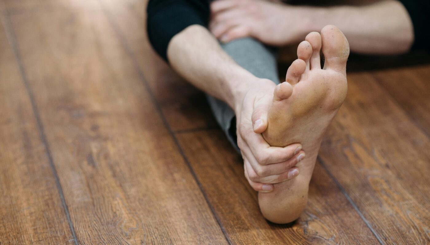 Photo by Pavel Danilyuk: https://www.pexels.com/photo/person-stretching-at-gym-on-wooden-floor-6926012/