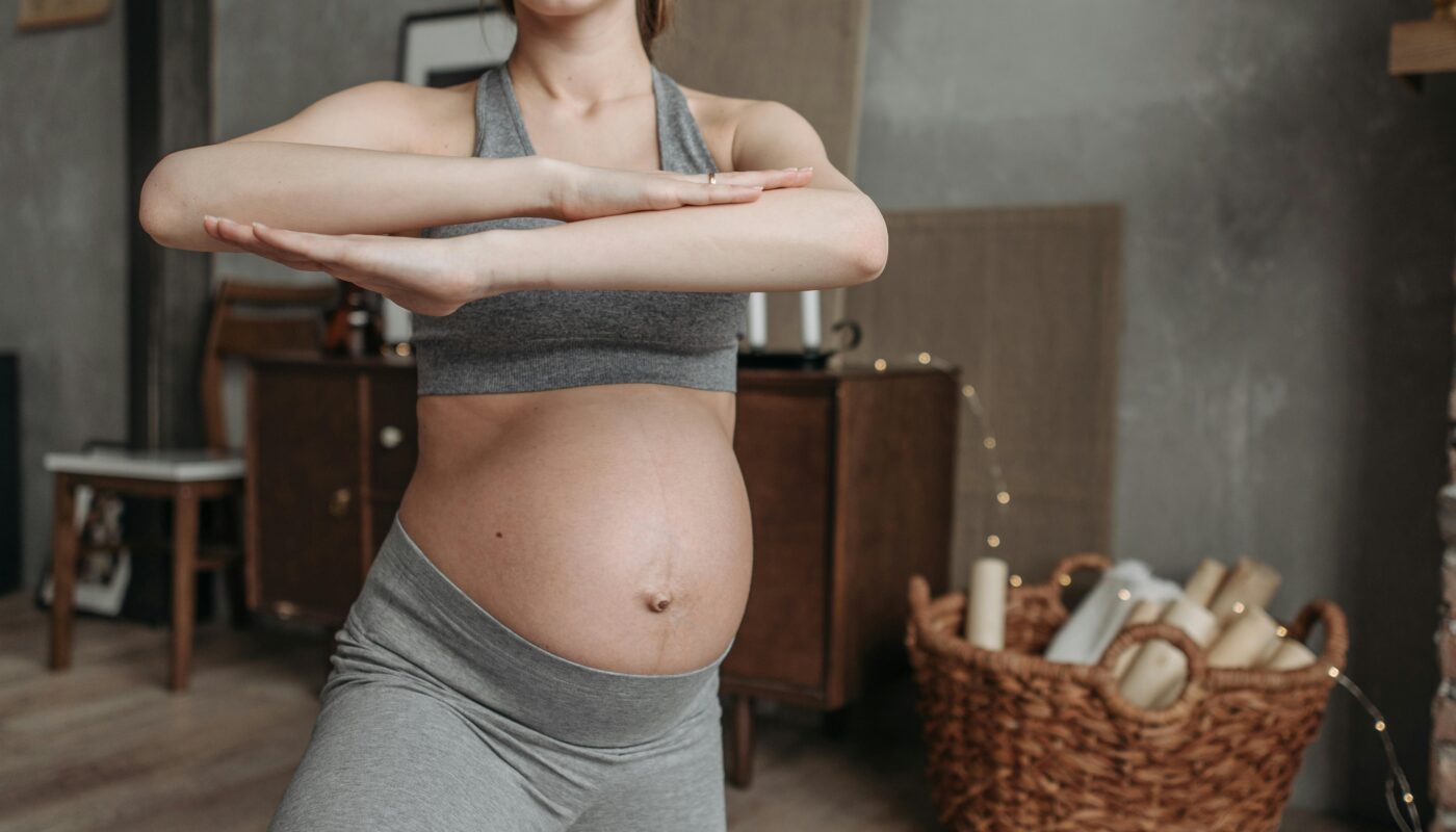 Photo by Pavel Danilyuk: https://www.pexels.com/photo/a-pregnant-woman-in-sports-bra-in-yoga-pose-7055687/