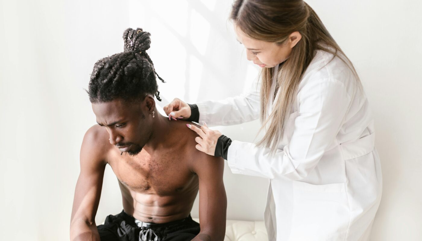 Photo by RDNE Stock project: https://www.pexels.com/photo/a-woman-putting-needles-in-man-shoulder-8312853/