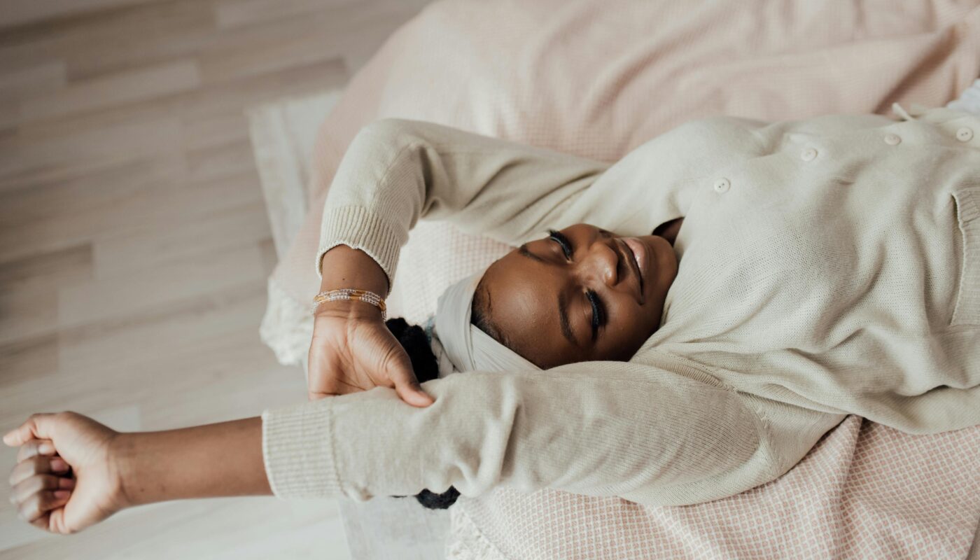 Photo by Arina Krasnikova: https://www.pexels.com/photo/a-woman-stretching-while-lying-in-bed-7005425/