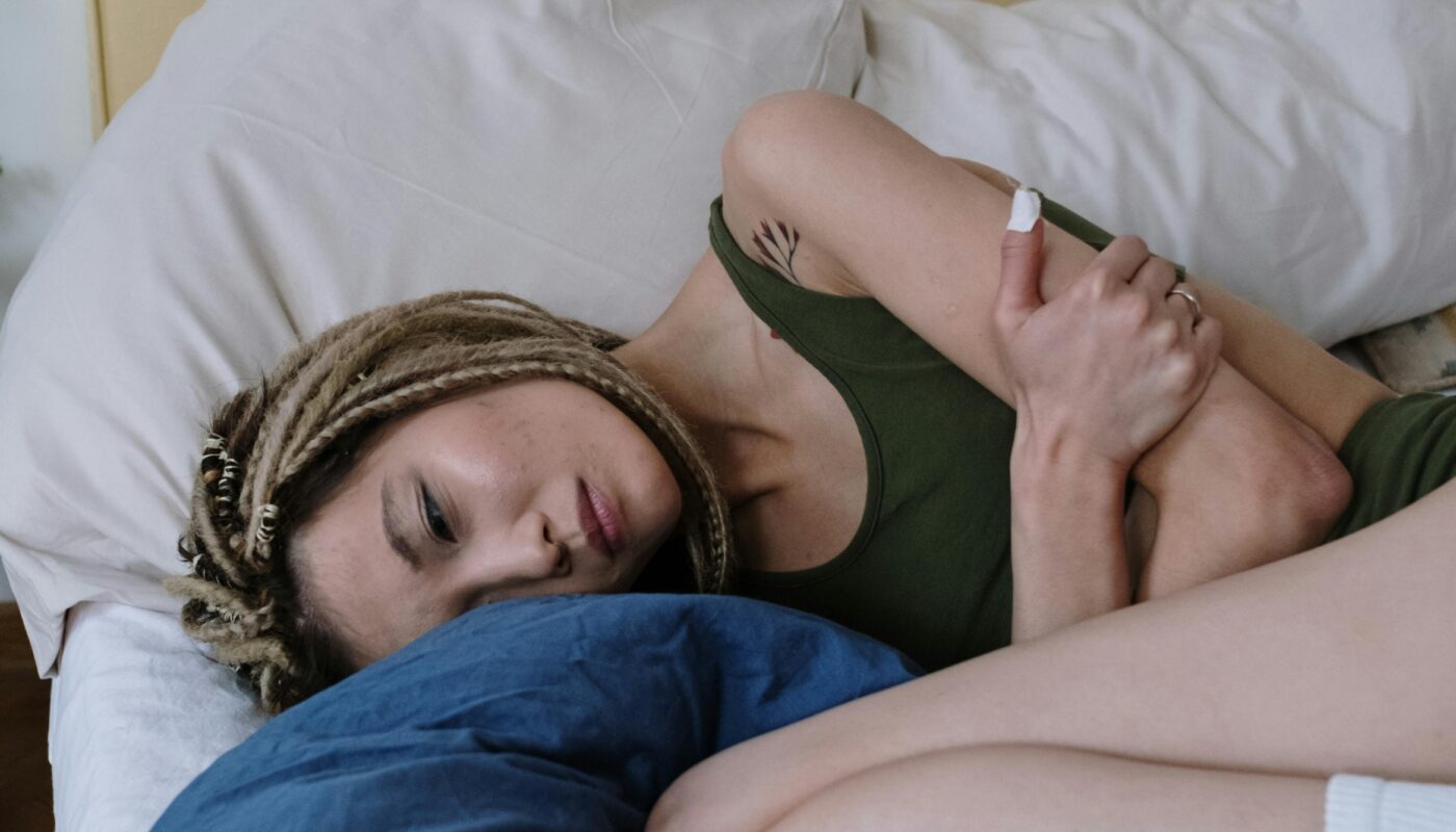 Photo by cottonbro studio: https://www.pexels.com/photo/woman-suffering-from-a-stomach-pain-lying-down-on-bed-6542696/