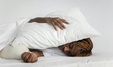Photo by KATRIN BOLOVTSOVA: https://www.pexels.com/photo/man-sleeping-with-pillow-on-his-head-7445324/