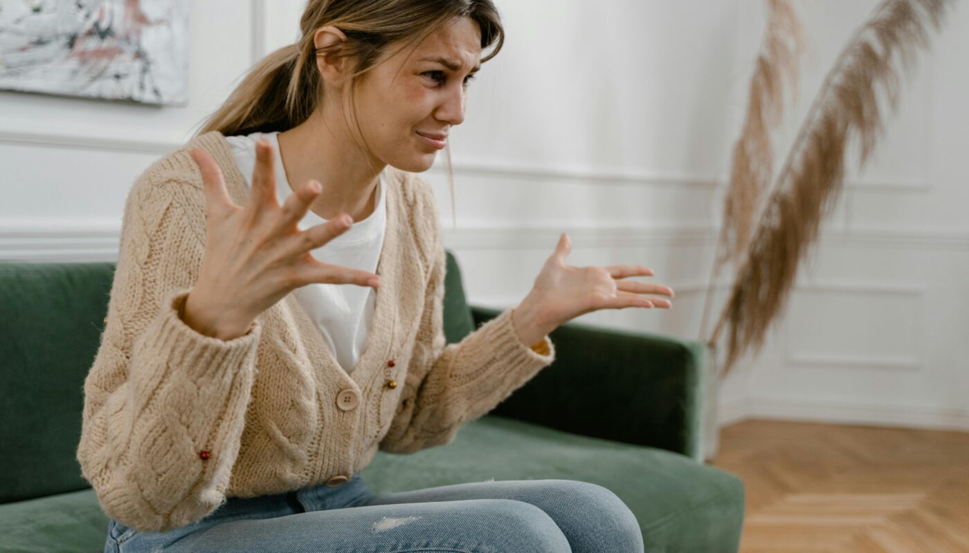 Photo by MART PRODUCTION: https://www.pexels.com/photo/a-sad-woman-sitting-on-a-sofa-7699356/