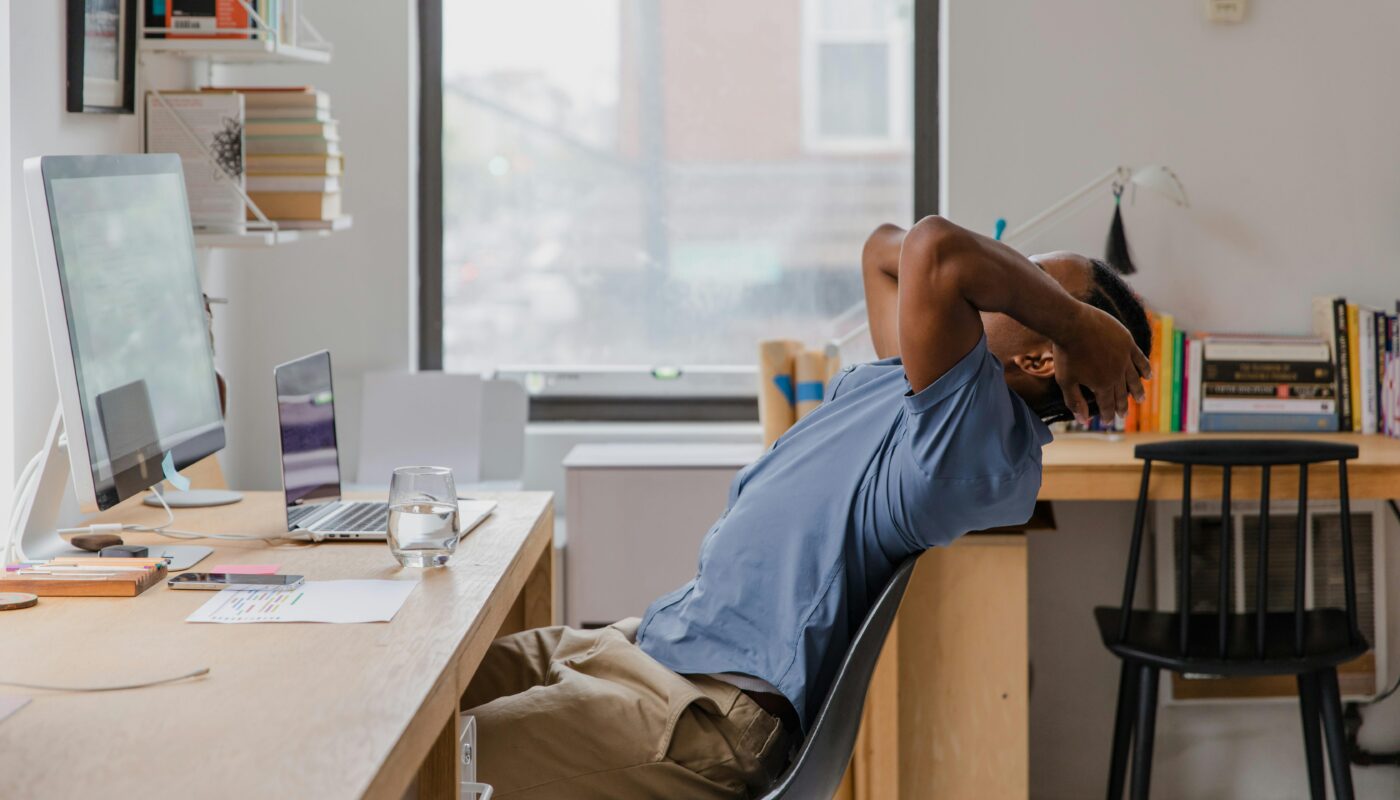 Photo by RDNE Stock project: https://www.pexels.com/photo/man-with-hands-in-hair-sitting-in-office-10376163/