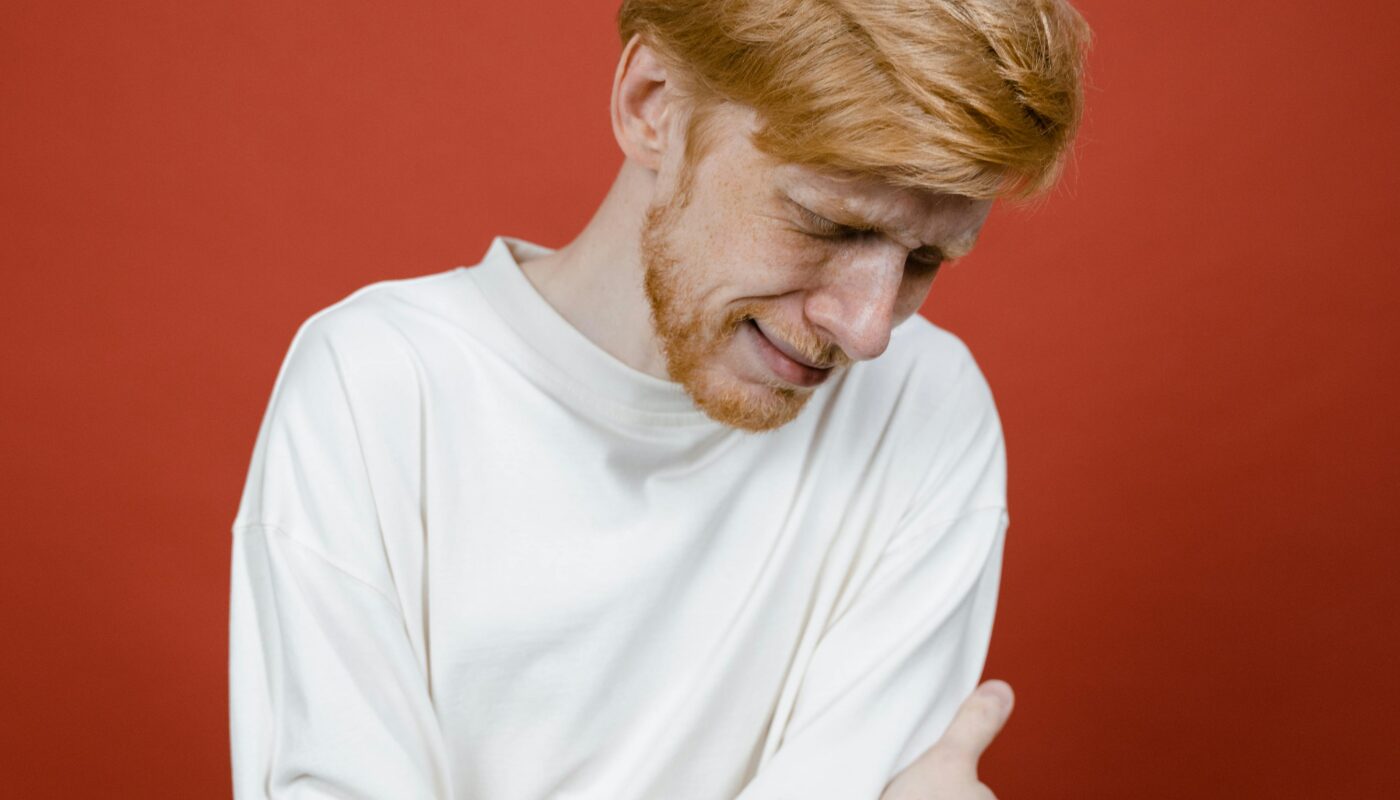 Photo by Tima Miroshnichenko: https://www.pexels.com/photo/man-in-white-long-sleeve-shirt-standing-near-red-wall-and-crying-8727345/