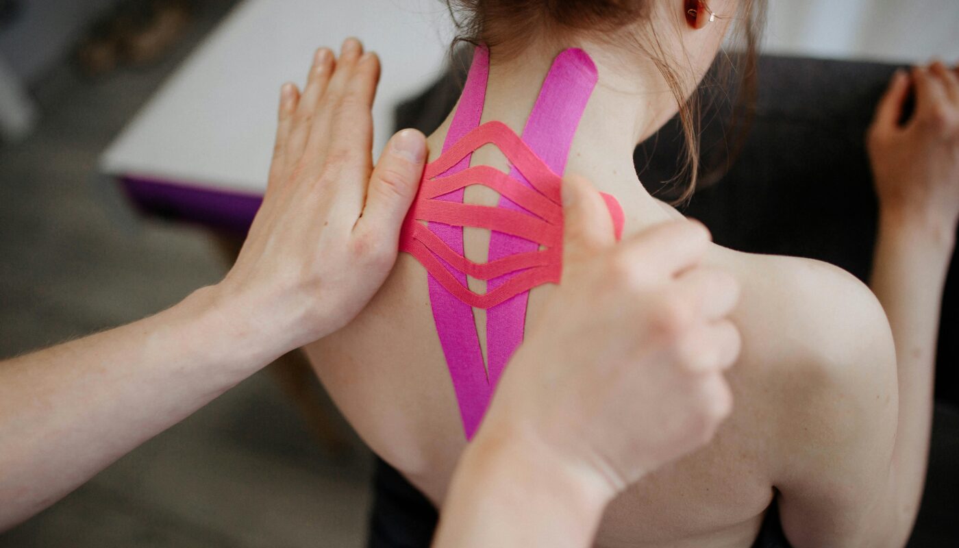 Photo by Danik Prihodko: https://www.pexels.com/photo/close-up-of-person-taping-client-back-8219057/
