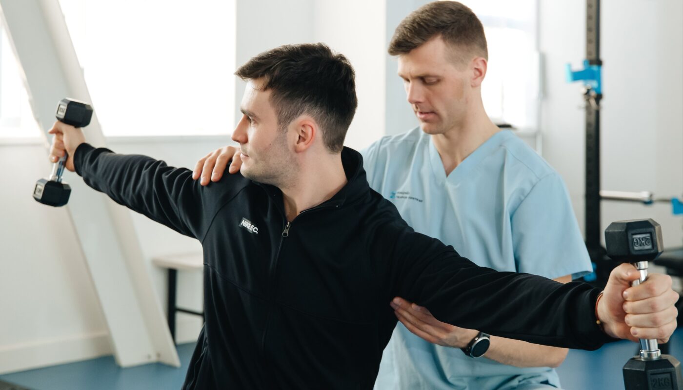 Photo by Funkcinės Terapijos Centras: https://www.pexels.com/photo/man-supporting-patient-who-lifting-dumbbells-20860623/