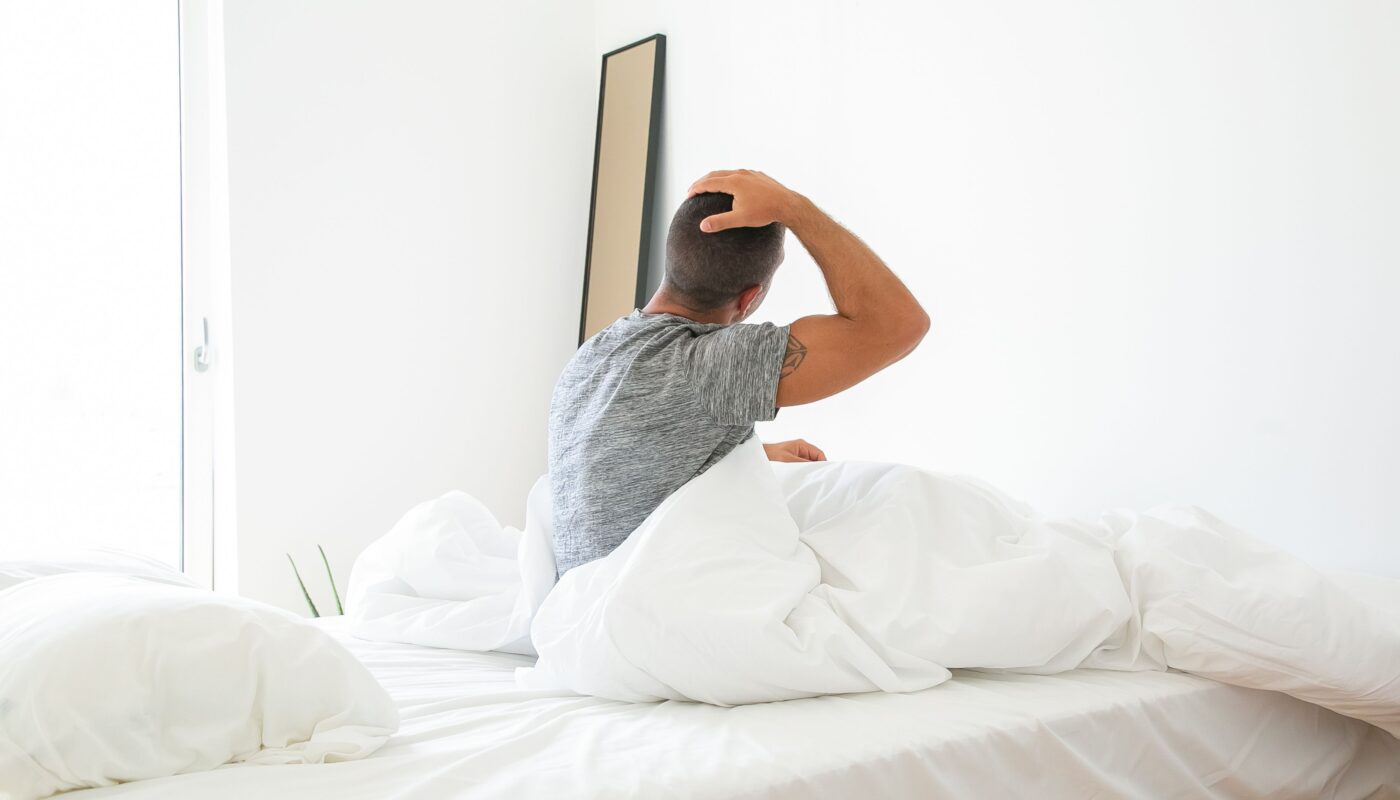 Photo by Kampus Production: https://www.pexels.com/photo/man-sitting-on-bed-while-stretching-his-neck-5990966/