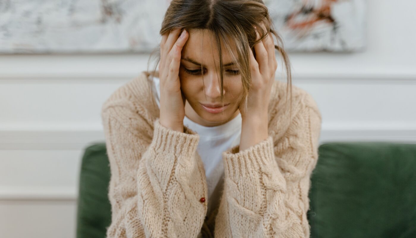 Photo by MART PRODUCTION: https://www.pexels.com/photo/a-sad-woman-sitting-on-a-sofa-7699482/