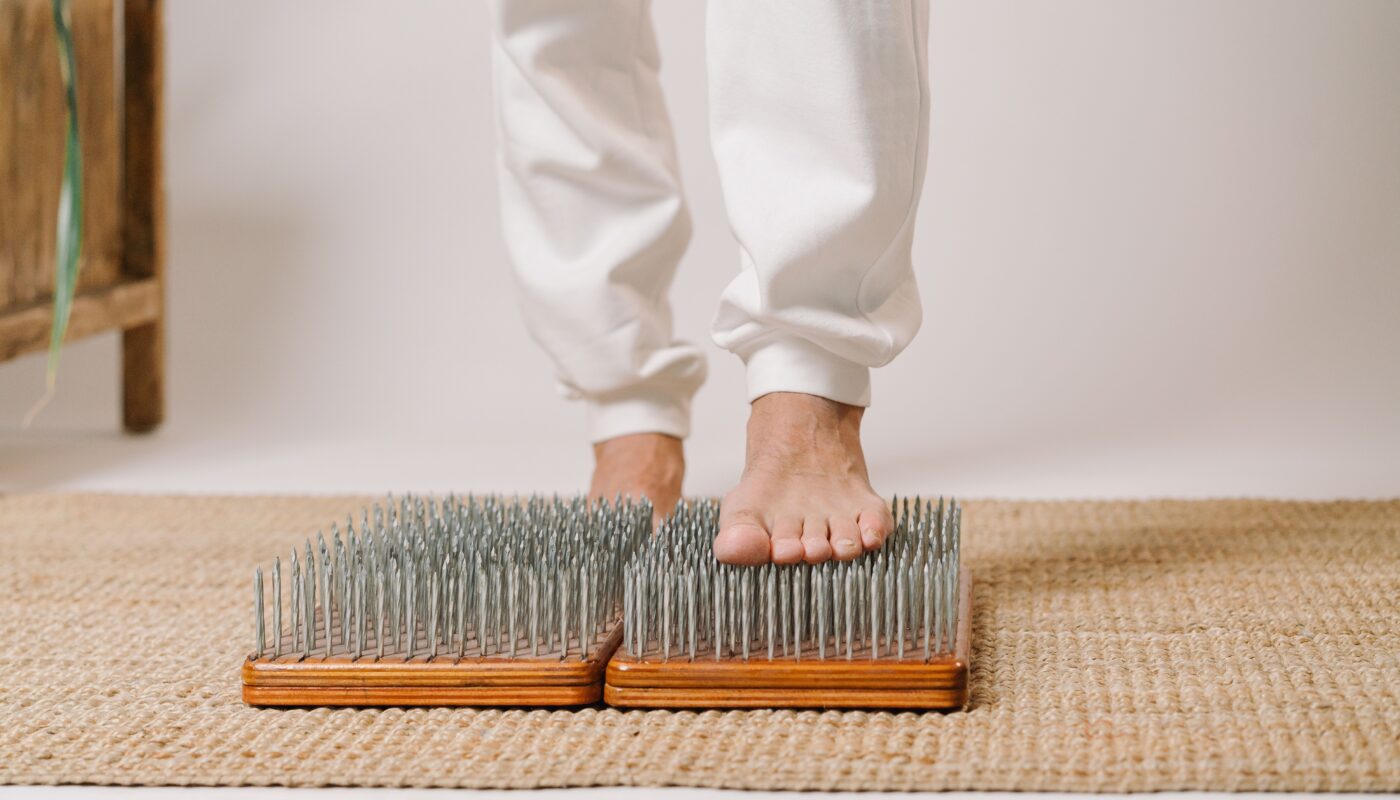 Photo by Mikhail Nilov: https://www.pexels.com/photo/person-standing-barefoot-on-sadhu-board-6943895/