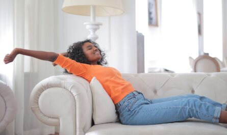 Photo by Andrea Piacquadio: https://www.pexels.com/photo/woman-in-orange-t-shirt-and-blue-denim-jeans-lying-on-white-sofa-3960141/