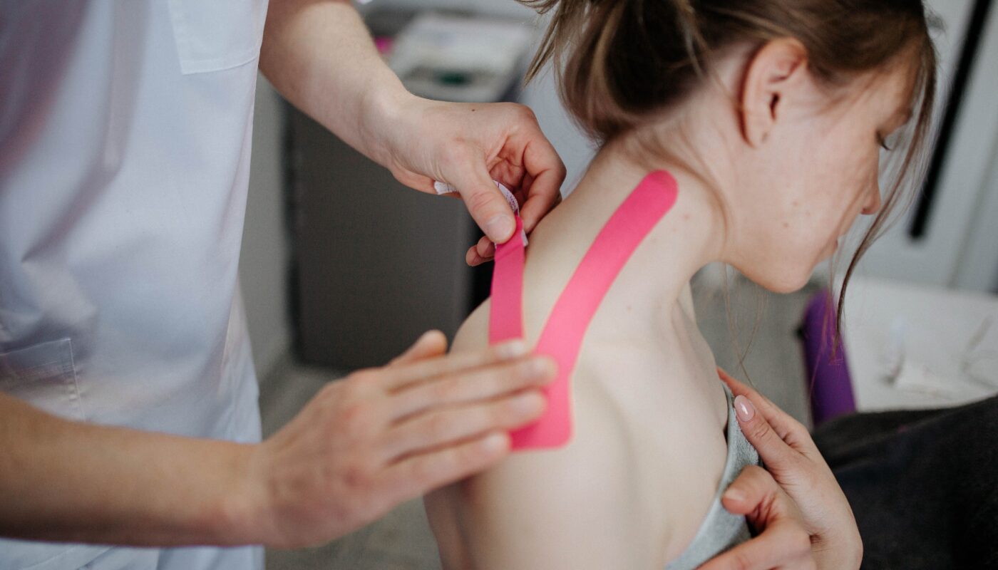 Photo by Danik Prihodko: https://www.pexels.com/photo/person-making-taping-to-woman-s-neck-8219055/