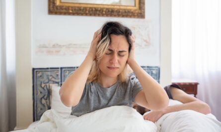 Photo by Kampus Production: https://www.pexels.com/photo/woman-in-gray-shirt-holding-her-head-while-sitting-on-the-bed-7556601/