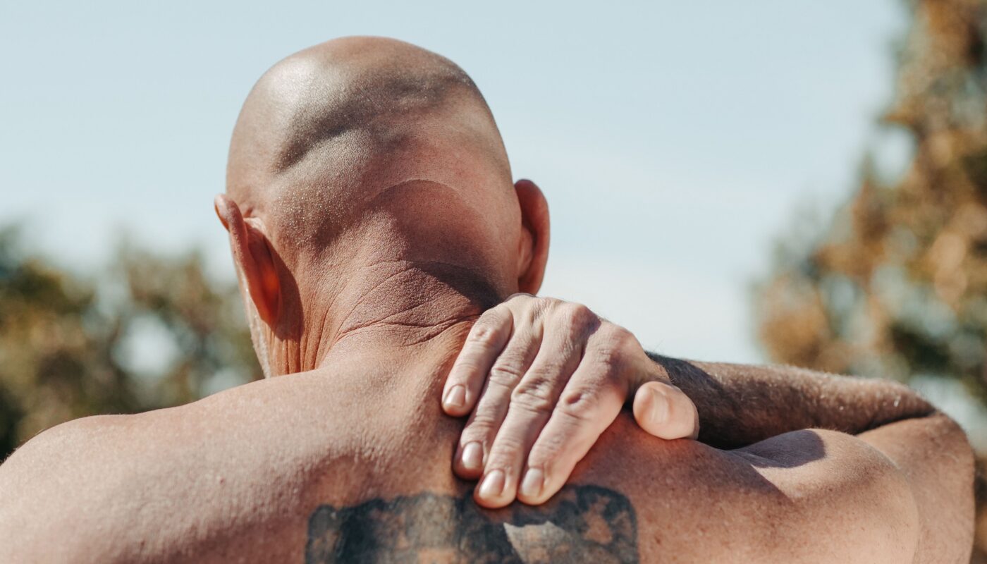Photo by Kindel Media: https://www.pexels.com/photo/man-with-tattoo-on-his-back-massaging-his-neck-7298432/