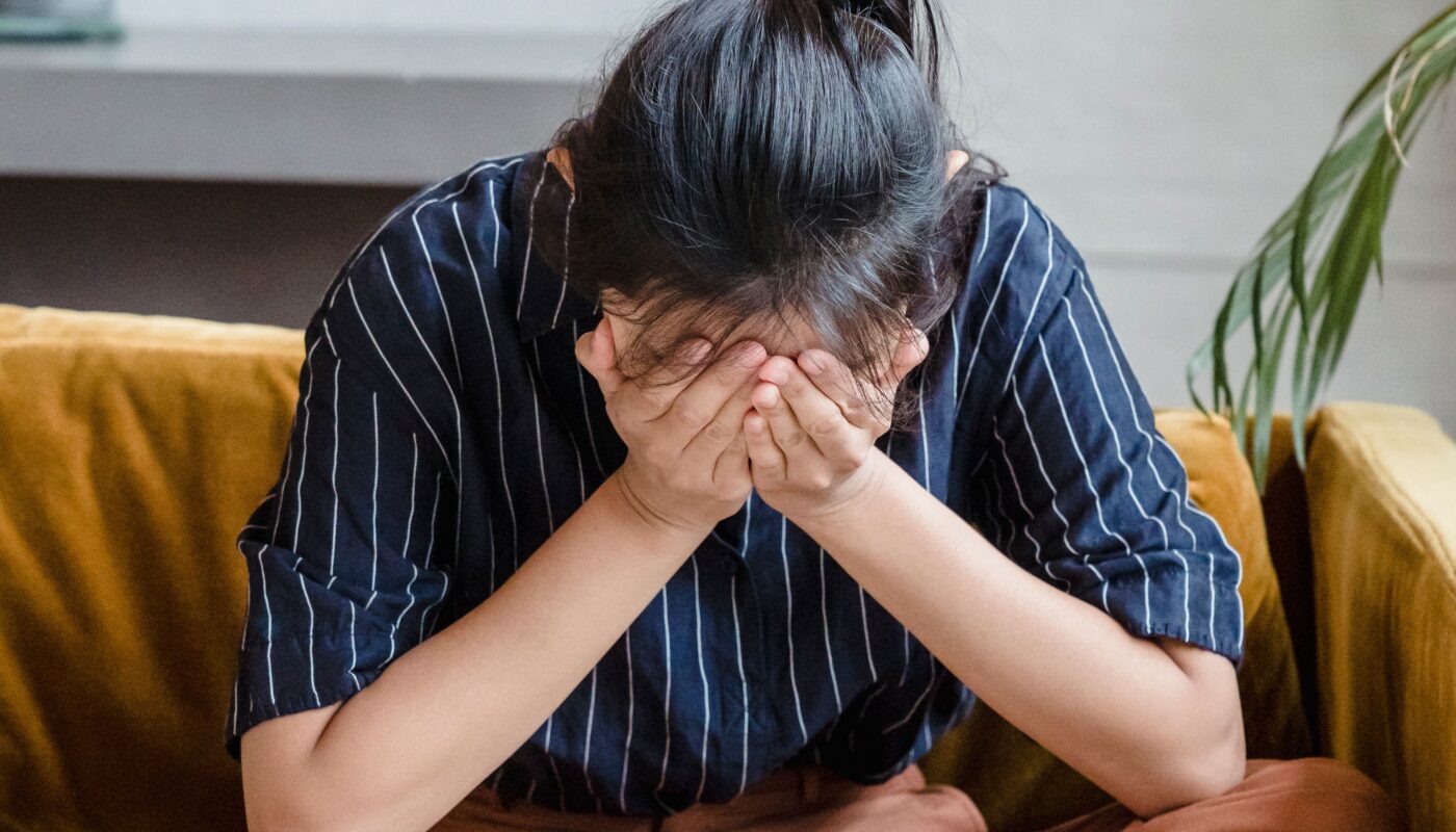 Photo by Timur Weber: https://www.pexels.com/photo/a-frustrated-woman-sitting-on-a-couch-while-covering-her-face-using-her-hands-8560696/